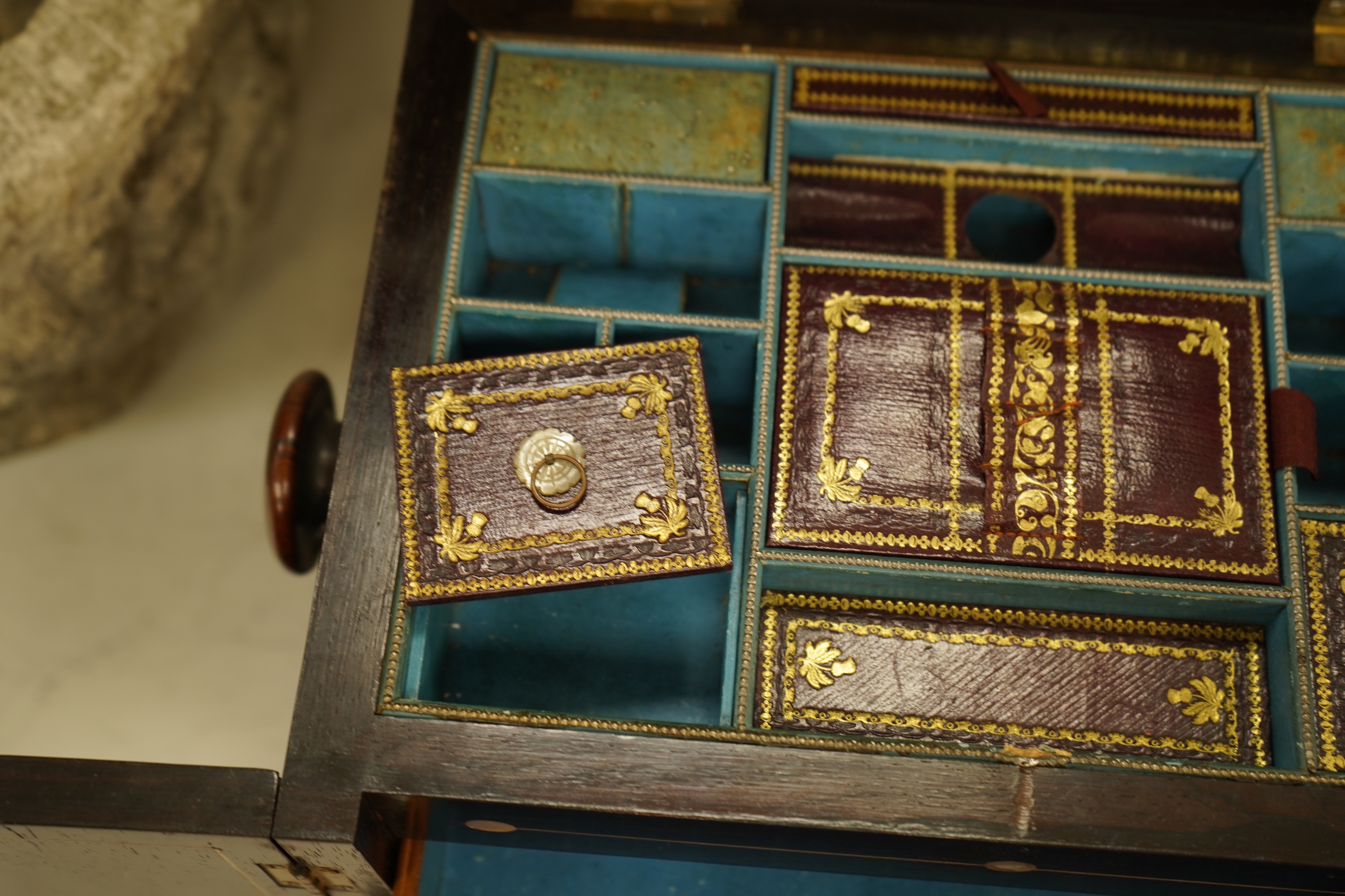 A William IV rosewood and mother of pearl inlaid sewing and writing cabinet with tooled Moroccan leather fitted interior, 37cm high